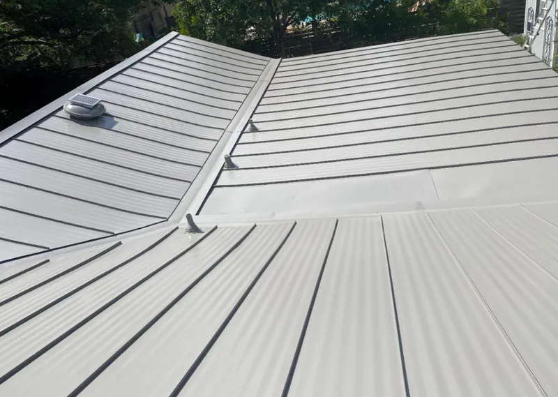 Solar attic fan installed on a metal roof for Roof Ventilation in Martin